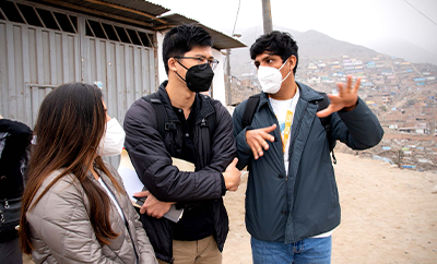Image: Alexander Chu stands in a group of people wearing medical masks in Lima, Peru.