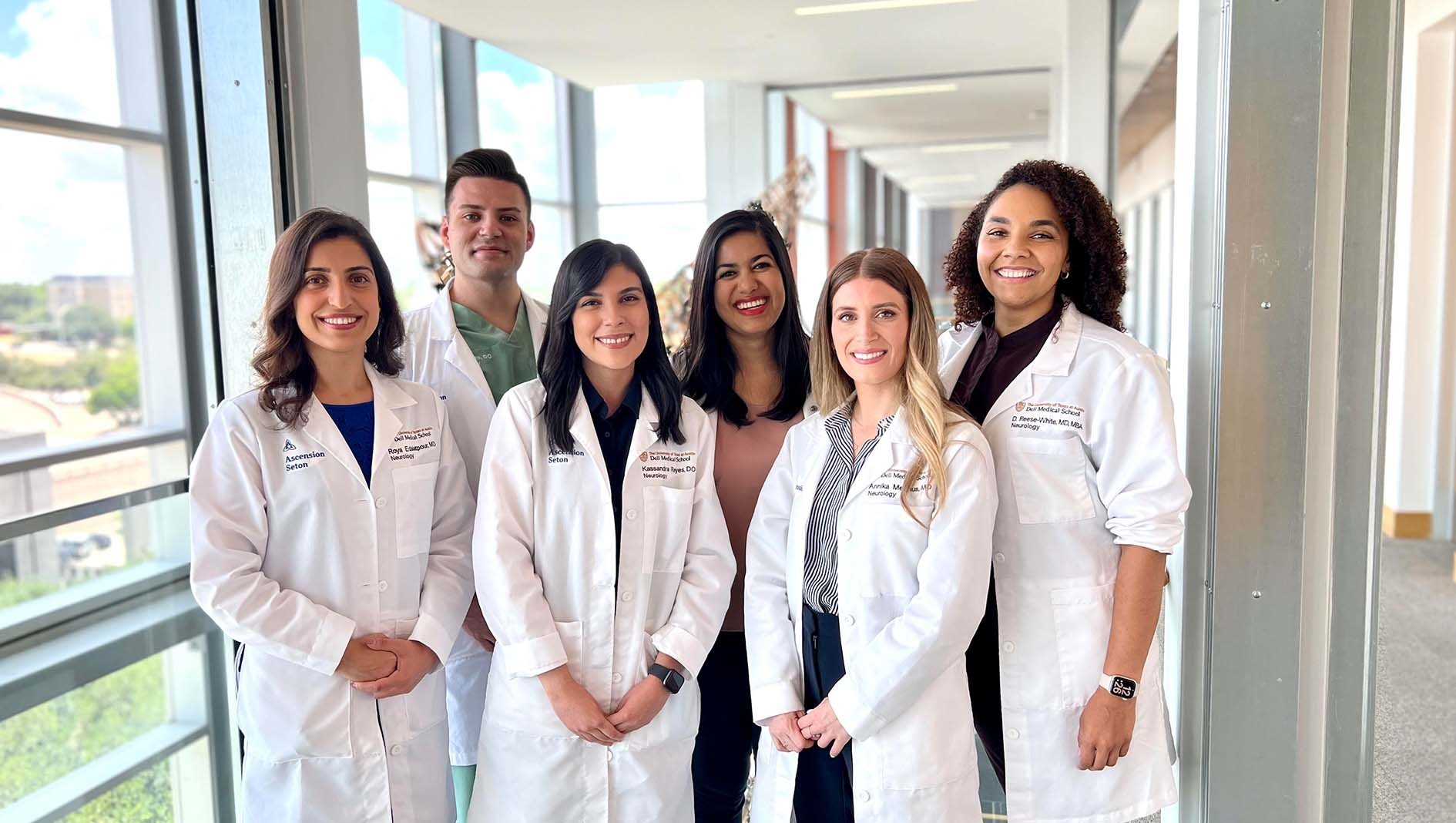 Neurology residents pose together in a group on the Dell Medical School campus.