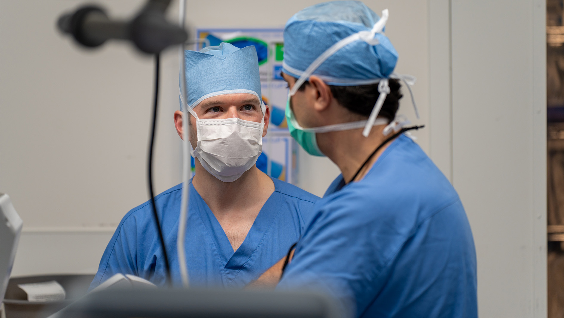 Two members of the Division of Cardiovascular and Thoracic Surgery in an operating room during a surgical procedure.