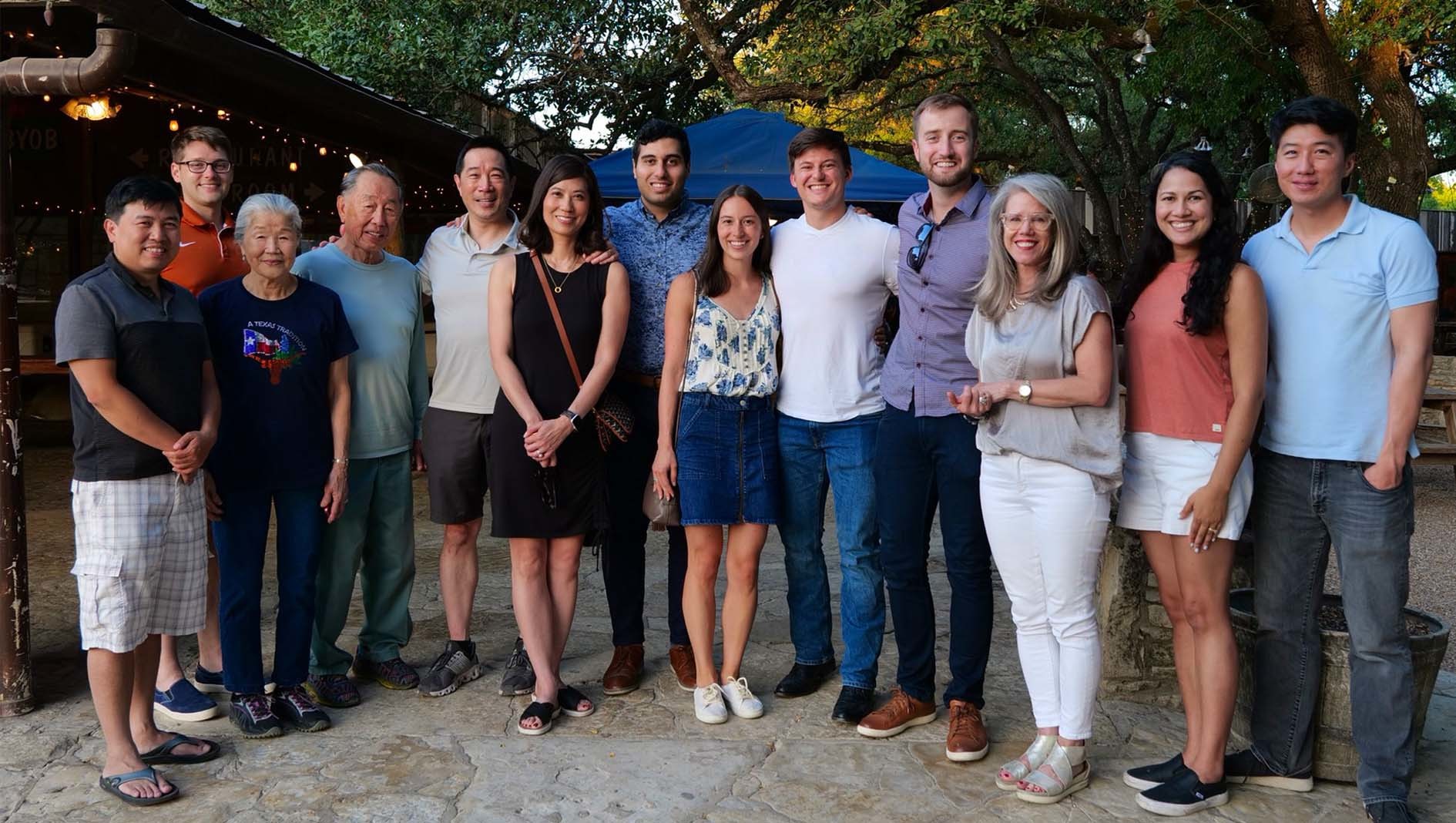 Faculty members affiliated with the Ophthalmology Residency stand together for a portrait outdoors at restaurant in Austin.