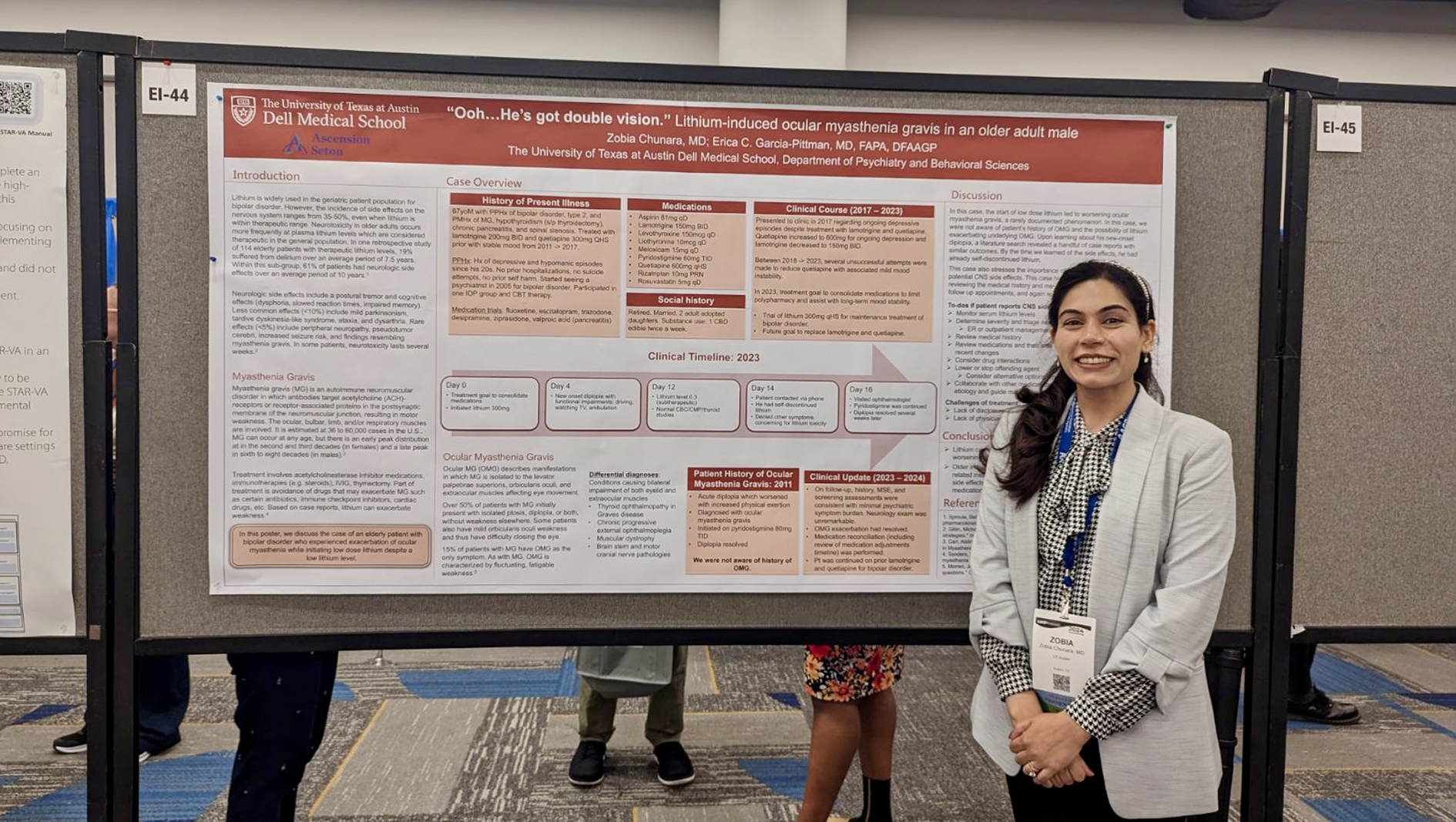 A geriatric psychiatry fellow poses in front of her research poster.