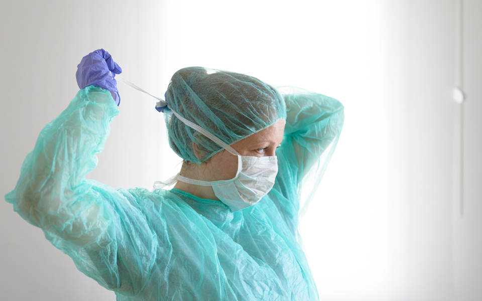 A doctor wearing a medical mask and personal protective equipment.