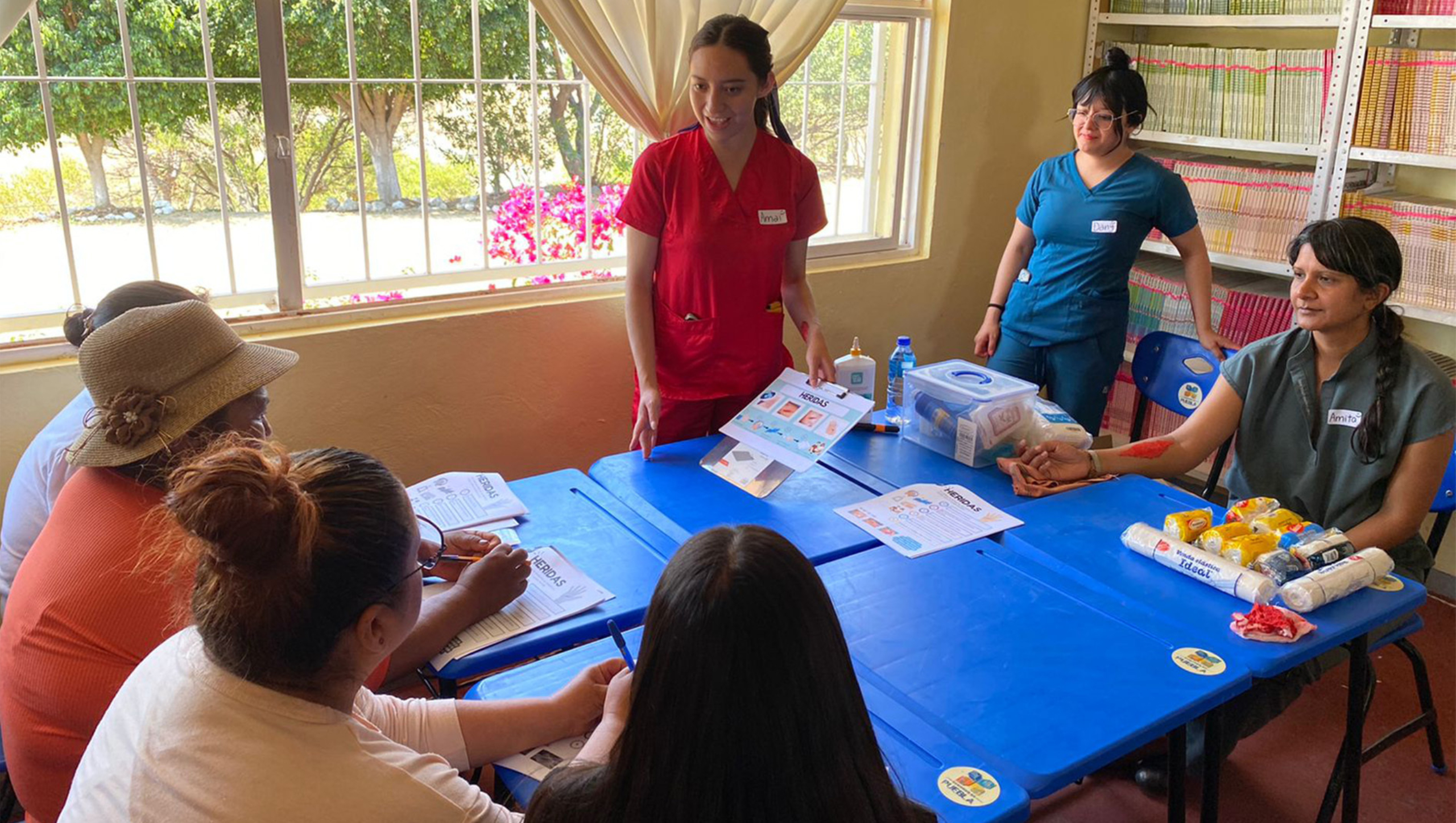 Community health promotors discuss health information and first aid with community members.