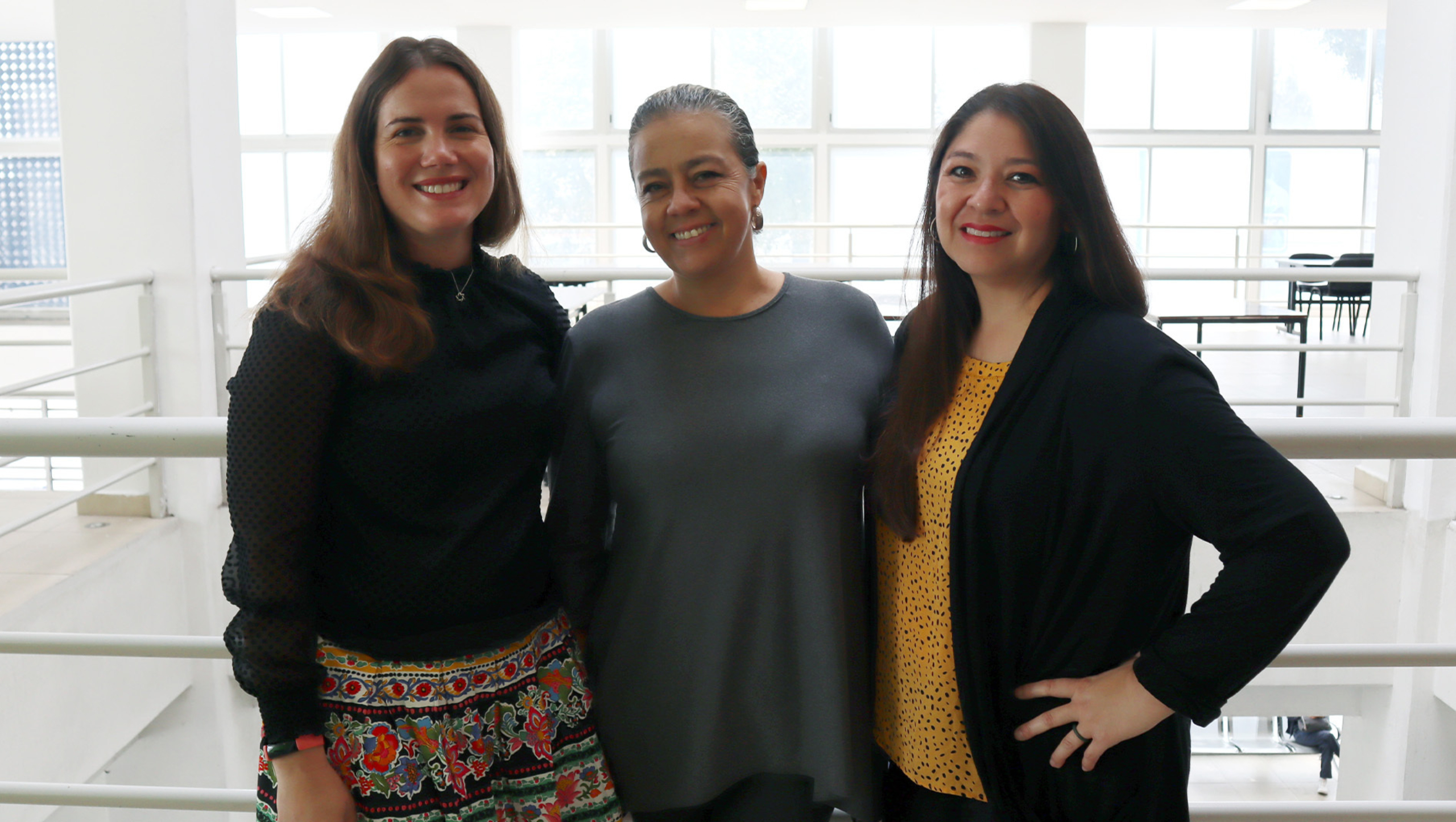 Claire Selinger, Minou del Carmen Arevalo Ramirez and Kristin Escamilla stand together for a group photo.