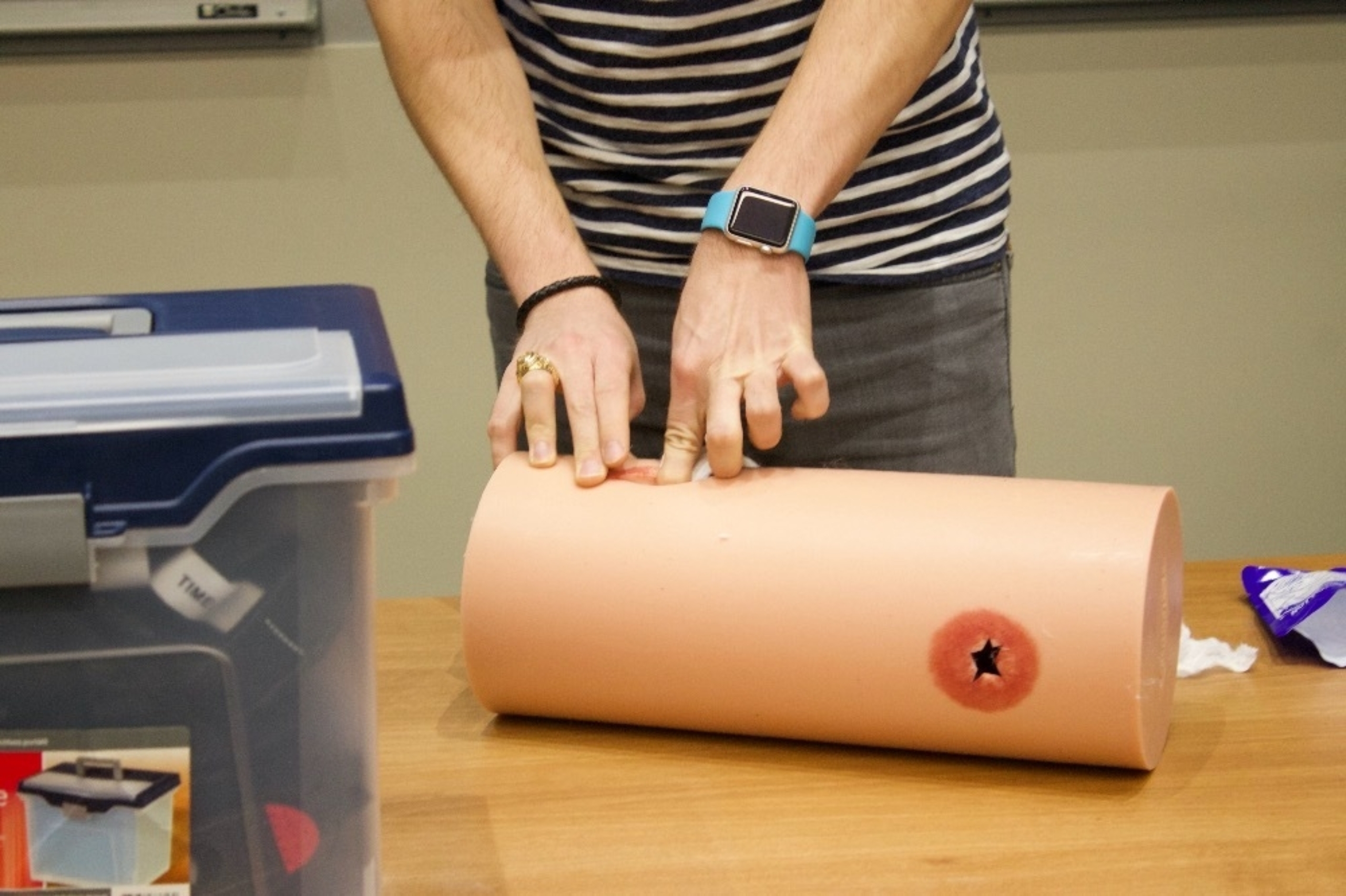 A Stop the Bleed instructor demonstrates an activity relating to puncture wounds.