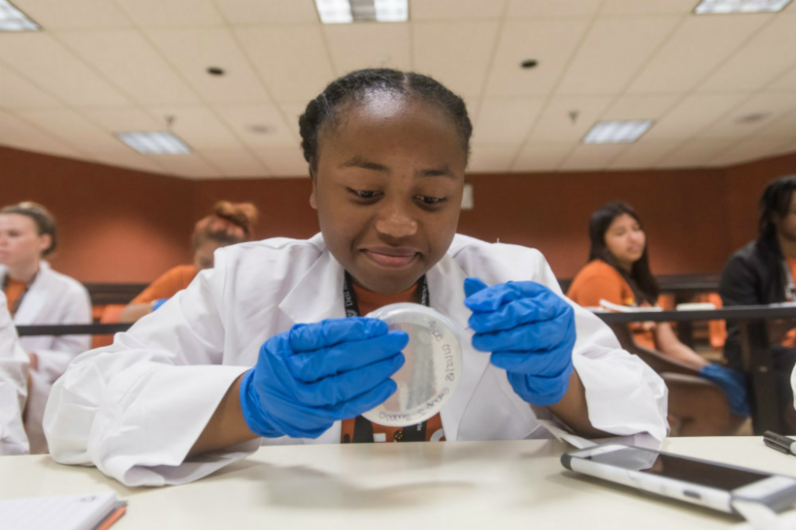 A summer camp participant engages in a microbiology experiment