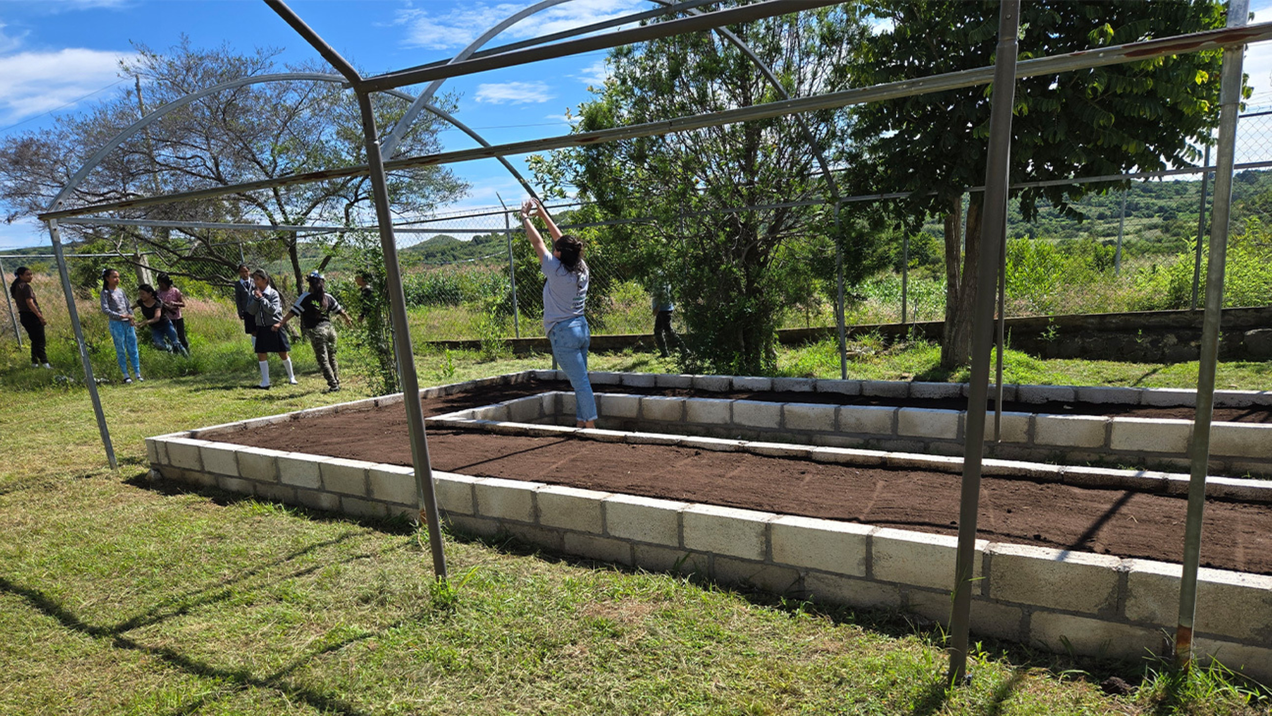 Members of the Division of Global Health, the Eden Lab and others participating in gardening activities.