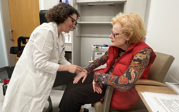 Leorah Freeman treating an elderly patient in a care room.